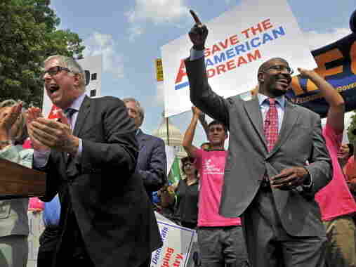 Van Jones (right) of the American Dream Movement, rallies with federal employees and progressive groups in front of the Capitol on Thursday, urging lawmakers to come to a fair deal on the budget.