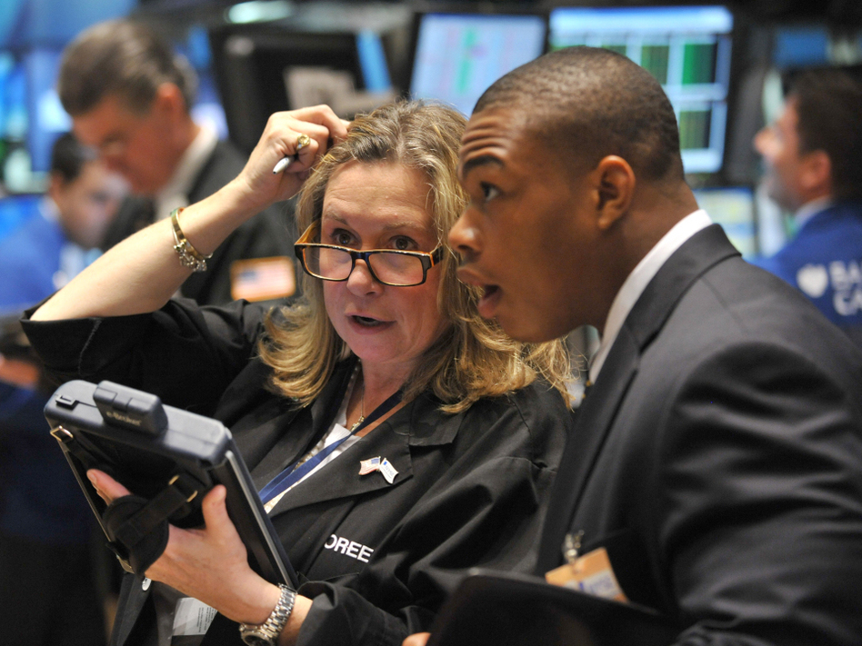 Traders worked on the floor of the New York Stock Exchange on Monday. The Dow Jones Industrial Average fell sharply after the opening bell, and trading continued to be volatile. (Stan Honda/AFP/Getty Images)