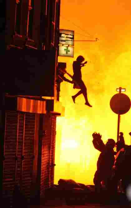 A woman can be seen jumping from a burning building in Croydon on Aug. 8. 