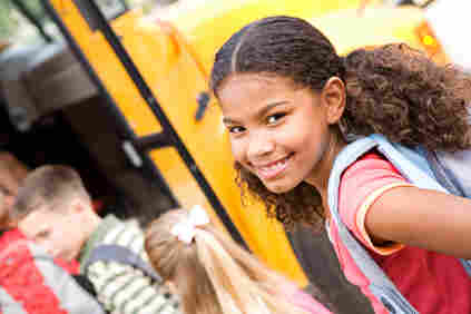 A girl in line for the school bus.