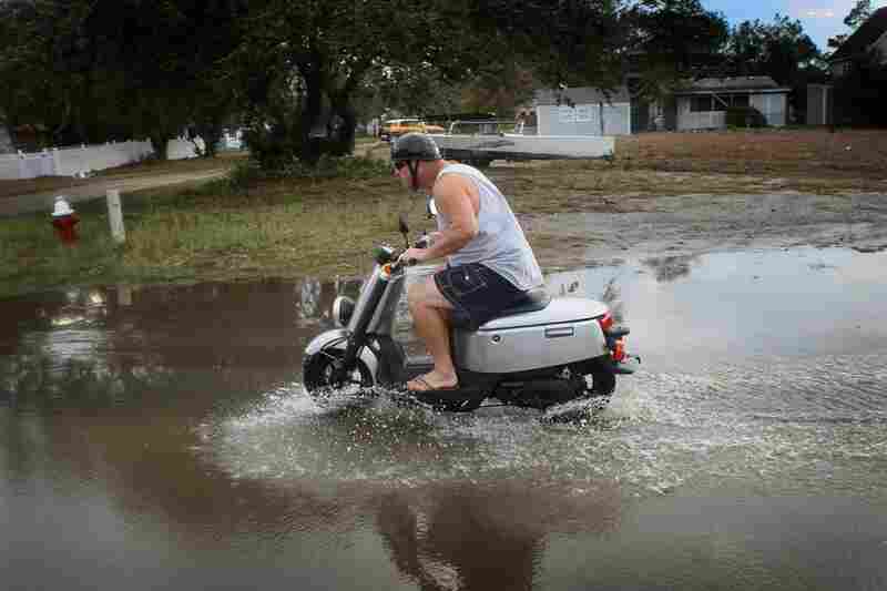Some flooding is no match for a scooter ride in Kill Devil Hills, N.C., on Sunday. 