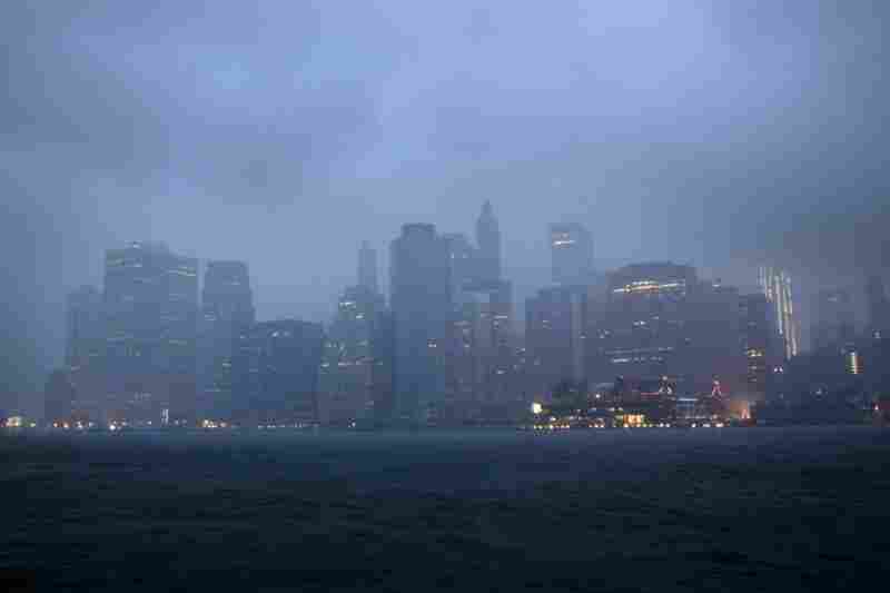 Lower Manhattan sits amid dark clouds as Irene bears down on New York early Sunday, bringing winds and rapidly rising seawater that threatened parts of the city. 