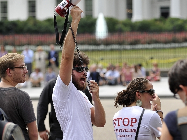 A protester uses a megaphone to shout slogans in front of the White House on Aug. 26, 2011. Demonstrators protested against the proposed Keystone XL oil pipeline project which, if approved, would run from Alberta, Canada to Texas through environmentally sensitive areas. (AFP/Getty Images)