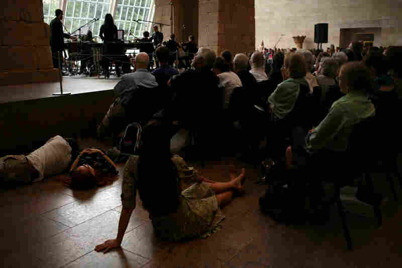 Audience members took to the floor at the Remembering September 11 concert by the Wordless Music Orchestra conducted by Ryan McAdams, presented at The Temple of Dendur in The Sackler Wing at The Metropolitan Museum of Art in Manhattan, NY on September 11, 2011.
