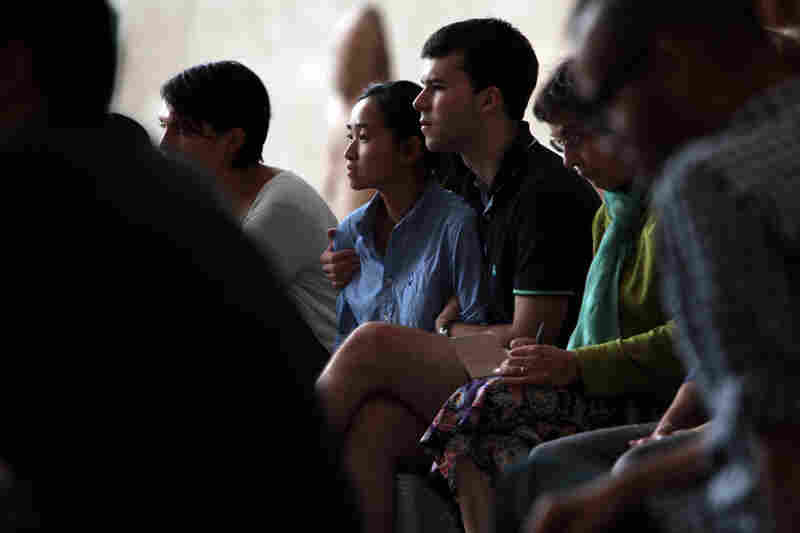 Members of the audience listen to Remembering September 11, a concert by the Wordless Music Orchestra conducted by Ryan McAdams presented at The Temple of Dendur in The Sackler Wing at The Metropolitan Museum of Art in Manhattan, NY on September 11, 2011.