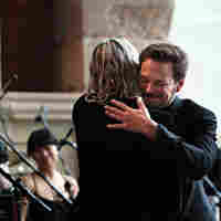 Wordless Music Orchestra conductor Ryan McAdams gives composer William Basinski a hug after the concert.