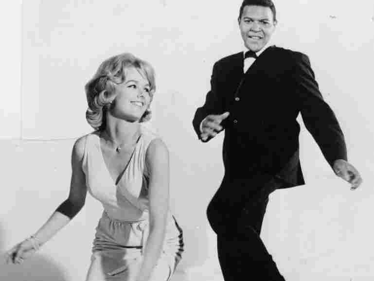 Chubby Checker twists with a friend.