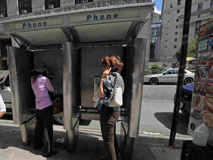 People use pay phones in Lower Manhattan.