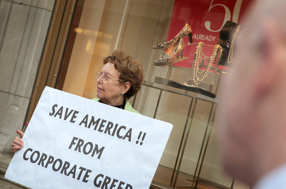 <p>During an Occupy Chicago demonstration at the Bank of America building in Chicago, Kaye Gamble holds a sign protesting corporate greed.</p> (Scott Olson/Getty Images)