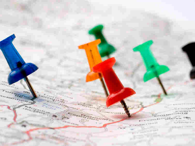 Thumbtacks on a map.