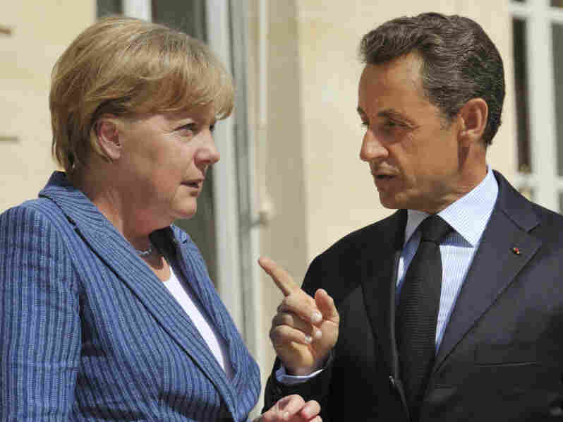 France's President Nicolas Sarkozy, right, speaks to German Chancellor Angela Merkel.