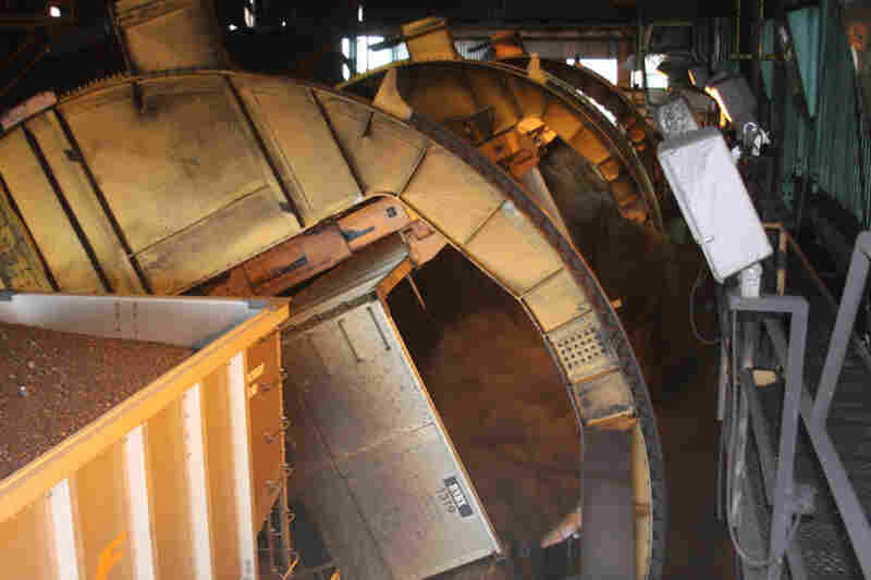 It's a dirty operation: As the train cars snake through a building, a large machine called a "double dumper" tips over and empties the coal, two cars at a time. 