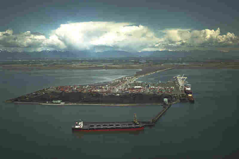 The port in Vancouver juts out into the Strait of Georgia on an artificial island. Wind kicks up coal particles from open conveyors and coal piles, and carries it out to sea. The port is currently undergoing a $5 million renovation to help mitigate that. The proposed port in Bellingham, backers say, will be more environmentally friendly. 