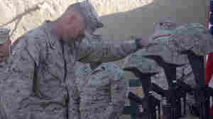 Lt. Col. Jason Morris pays his respects at a memorial service in Sangin, Afghanistan, on Nov. 26, 2010, for three Marines who were killed: Lance Cpl. Brandon Pearson, Lance Cpl. Matthew Broehm and 1st Lt. Robert Kelly. Morris commanded a battalion in volatile Helmand province that suffered the highest casualty rate of any Marine unit in the Afghanistan War.