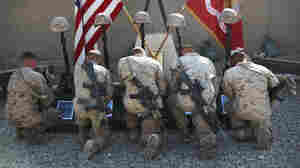 Marines with 3rd Battalion, 5th Marine Regiment, kneel before battlefield memorials for their fallen brothers during a farewell ceremony, Oct. 30, 2010.