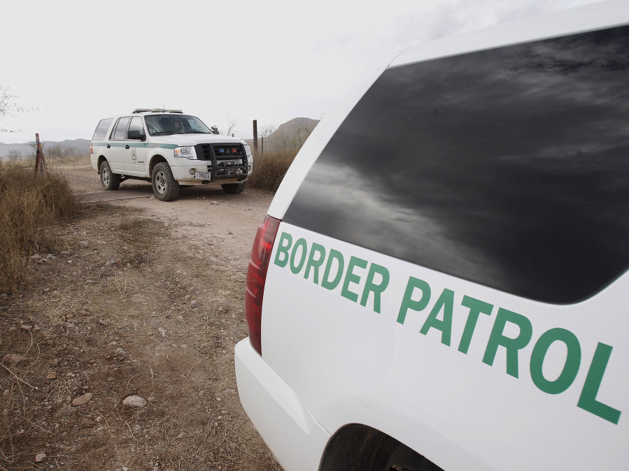 <p> U.S. Border Patrol vehicles drive from a checkpoint in December 2010, as teams of border officers comb the Arizona desert about 10 miles north of Mexico in search for a suspect in the fatal shooting of U.S. Border Patrol agent Brian Terry in the rugged terrain in Rio Rico, Ariz. </p> (ASSOCIATED PRESS)