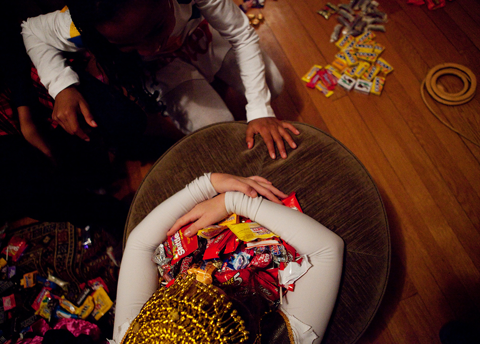 <p>Sierra Lewter grabs a coveted candy after trick-or-treating on Halloween. </p> (Melissa Forsyth/NPR)