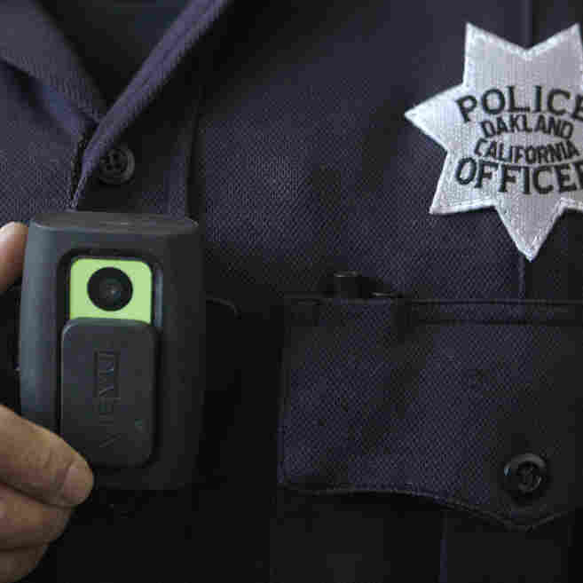 Officer Huy Nguyen shows a video camera worn by some officers in Oakland, Calif. Oakland and dozens of other police departments across the country are equipping officers with tiny body cameras to record anything from a traffic stop to a violent crime in progress. 