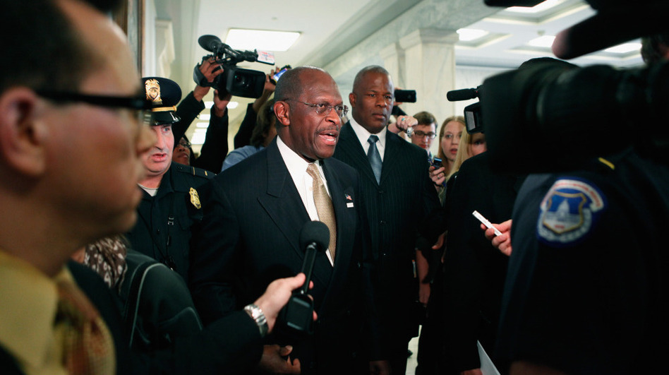 Tuesday: Republican presidential candidate Herman Cain is surrounded by police, body guards, staff members and journalists on Capitol Hill. (Chip Somodevilla/Getty Images)