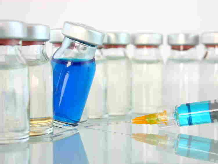 A bottle of blue medicine teeters.