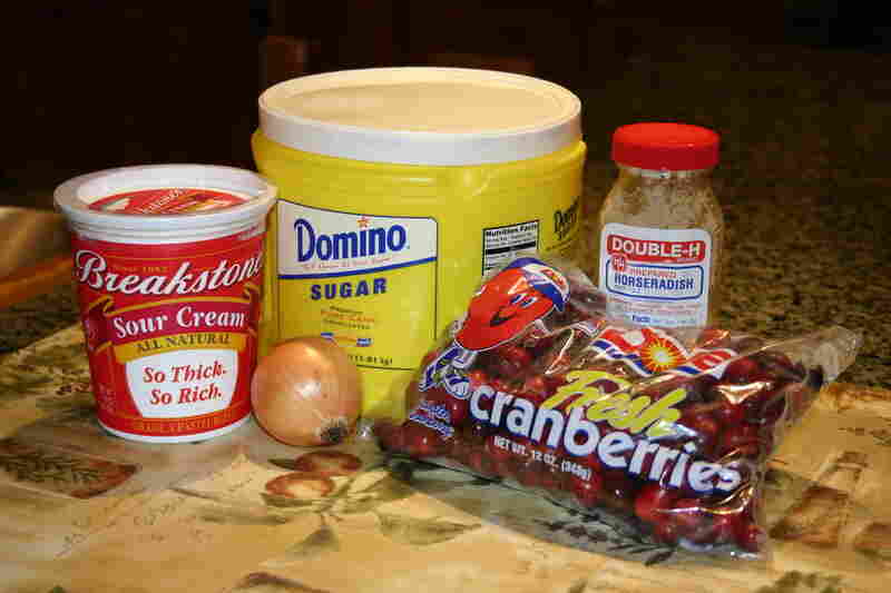 The ingredients: 2 cups whole raw cranberries; 1 small onion; 3/4 cup sour cream; 1/2 cup sugar; 2 tablespoons horseradish from a jar—white or red.