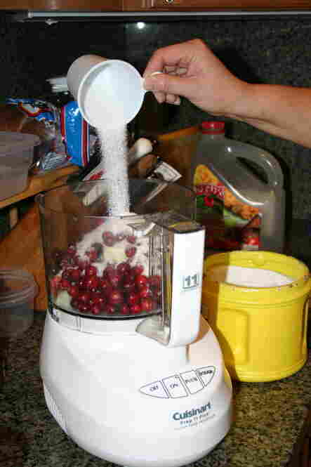 Combine cranberries, onion and sugar in a food processor.