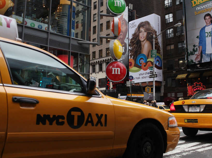 Taxis pass through Times Square in New York City.