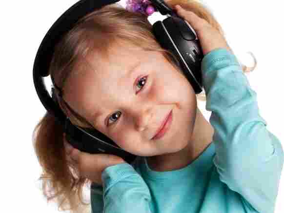 A young girl with headphones on