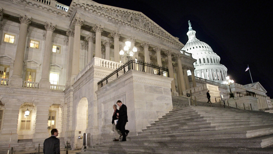 Congressmen walk down the steps of the House of Representatives as they work overnight on a spending bill in February. (J. Scott Applewhite/AP)