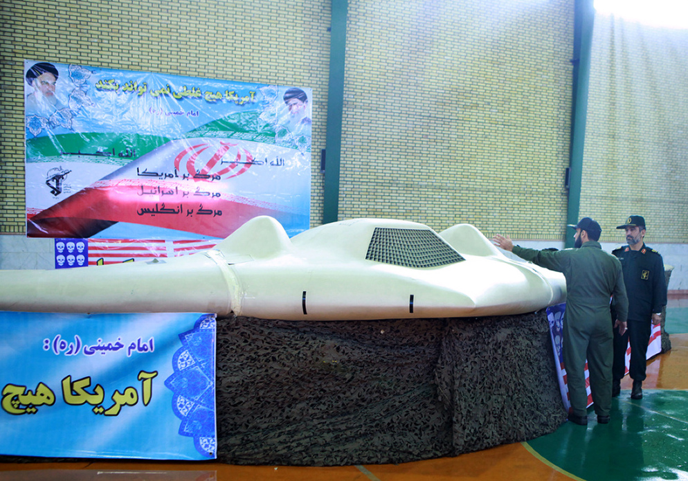A picture released by the official website of Iran's Revolutionary Guards on December 8, 2011 shows Iranian Revolutionary Guard, Brig. Gen. Amir-Ali Hajizadeh (R) looking at what Iranian officials claim is a U.S. RQ-170 Sentinel high-altitude reconnaissance drone that crashed in Iran on December 4. (AFP/Getty Images)