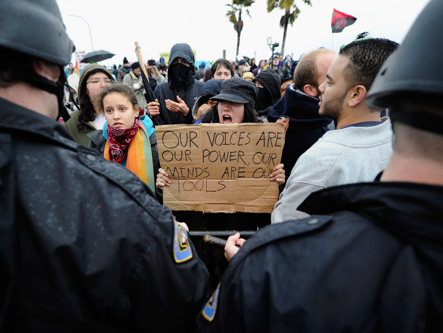 Occupy protesters clash with Long Beach Police Department officers after blocking the road leading to SSA Marine, a shipping company that is partially owned by investment bank Goldman Sachs, at the Port of Long Beach on Monday. (Getty Images)