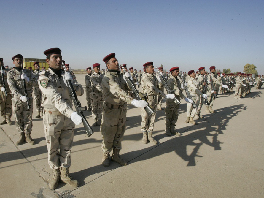 Iraqi soldiers take part in a graduation parade in Kirkuk on Monday. The oil-rich city is a mix of Kurds, Arabs, Turkmen and others. Its future status is a source of tension within Iraq. (AFP/Getty Images)