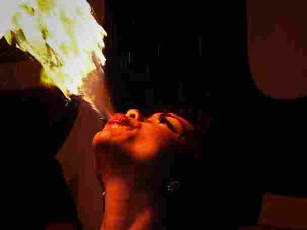A woman breathing fire