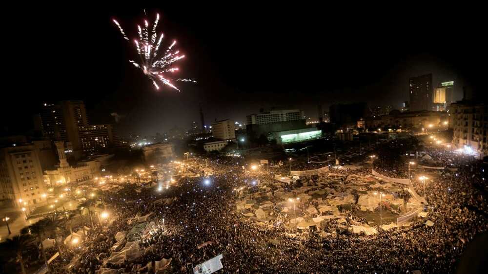 Egyptian anti-government protesters celebrate under fireworks at Cairo's Tahrir Square after President Hosni Mubarak stepped down.
