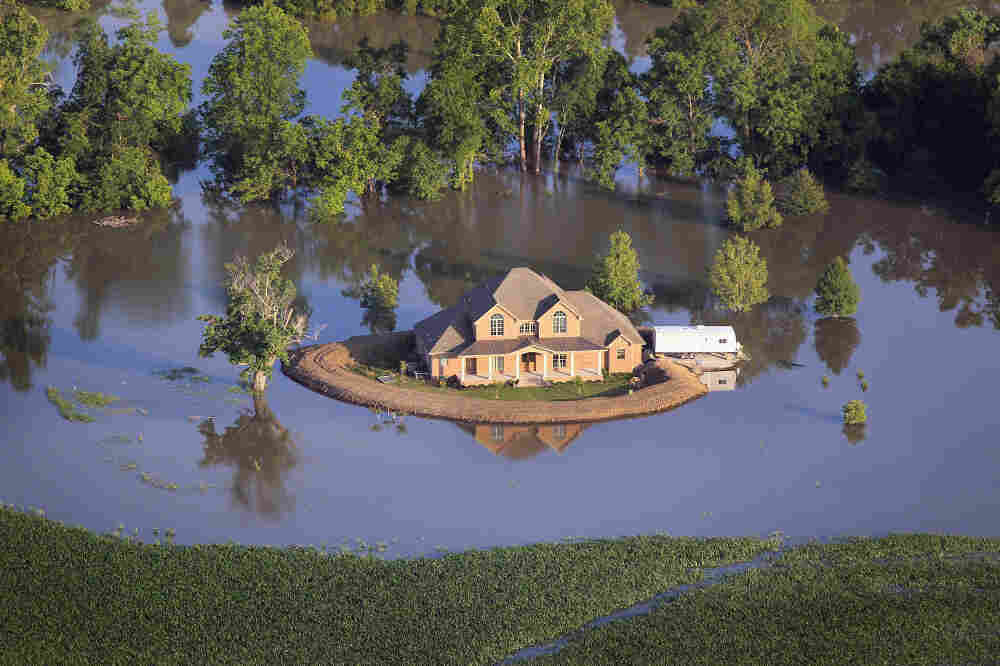 A levee protects a home surrounded by floodwaters from the Yazoo River near Vicksburg, Miss., May 18.