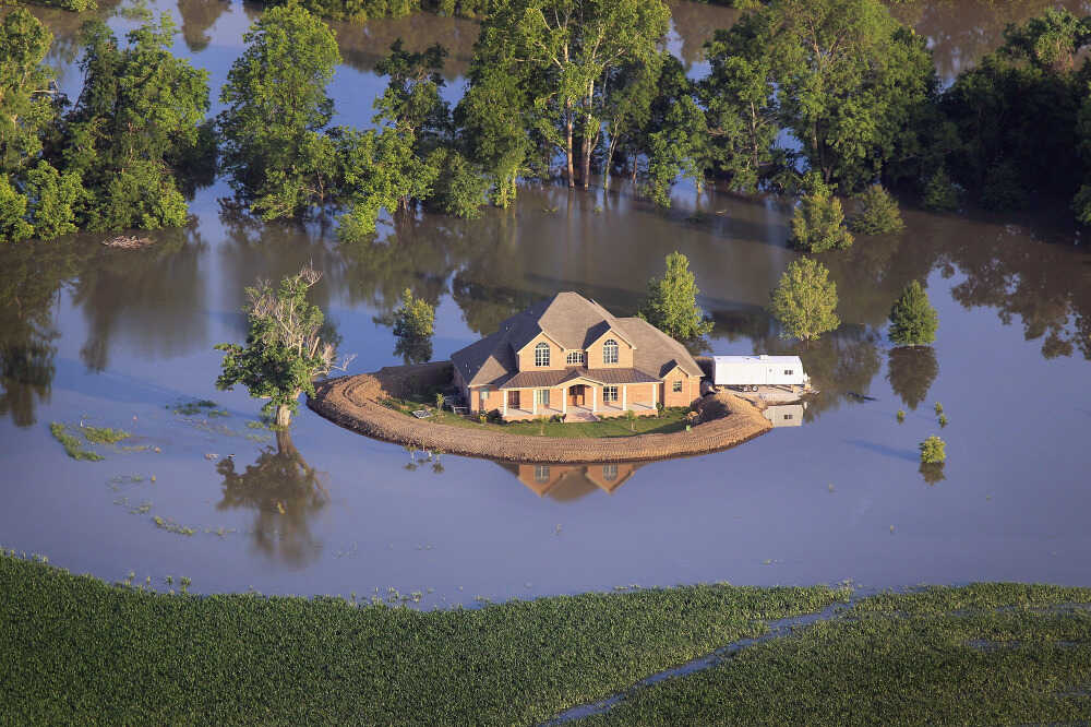 A levee protects a home surrounded by floodwaters from the Yazoo River near Vicksburg, Miss., May 18.