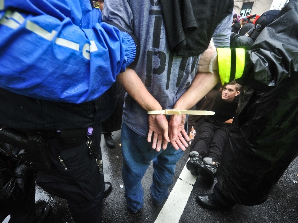 The arrest of an Occupy DC protester earlier this month in Washington — one type of arrest that would show up in the researchers' numbers. (Nicholas Kamm /AFP/Getty Images)
