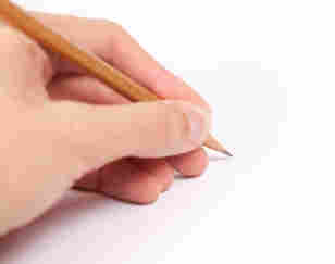 Left-handed person writing.