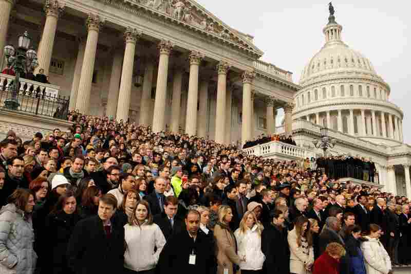 Members of Congress and their staff gather on the steps of the House of Representatives on Jan. 10 for a national moment of silence to honor the shooting victims. 