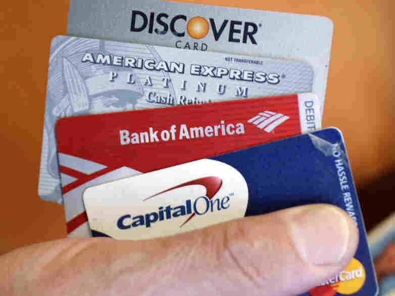 Steve Wheelock holds up his Discover Card along with his American Express, Bank of America and Capital One Visa credit cards in San Francisco, Wednesday, June 22, 2011. Discover Financial Services said Thursday, June 23, its second-quarter profit more than tripled as customers used their cards more and got better about making payments on time.