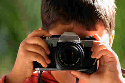 A boy takes a photo.
