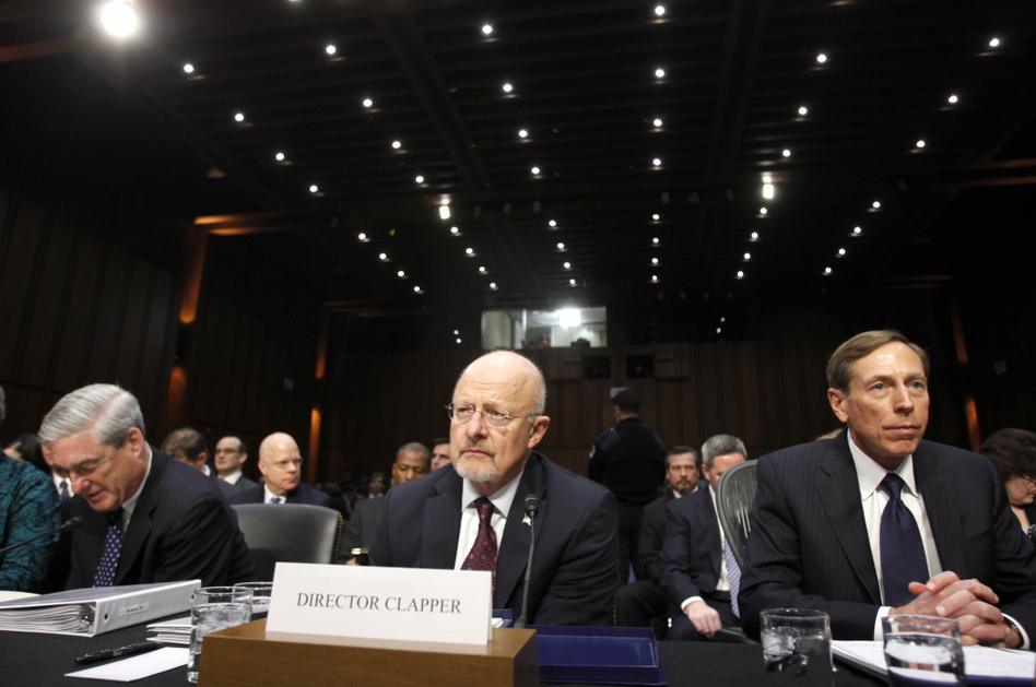 From left, FBI Director Robert Mueller, Director of National Intelligence James Clapper, and CIA Director David Petraeus take their seats on Capitol Hill in Washington on Tuesday, prior to testifying before the Senate Intelligence Committee hearing. (Jacquelyn Martin/AP)