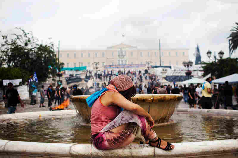 A woman recuperates in Athens' Syntagma Square after being gassed during a demonstration against austerity measures last summer.