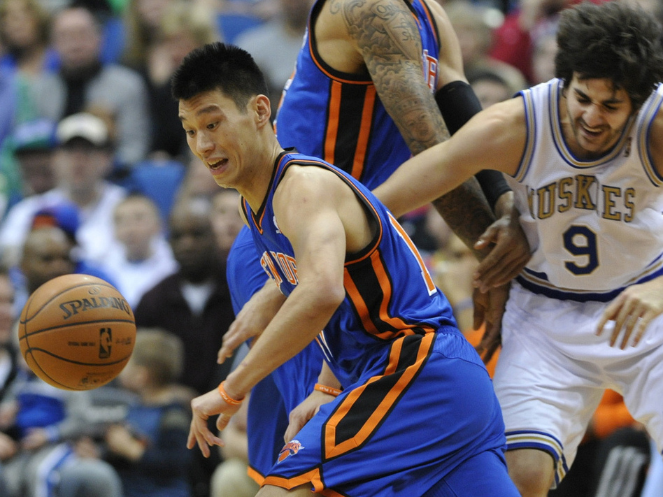 Jeremy Lin chases the loose ball in the first half of an NBA basketball game in Minneapolis. Lin is one of the few Asian-Americans in NBA history. (Jim Mone/AP)