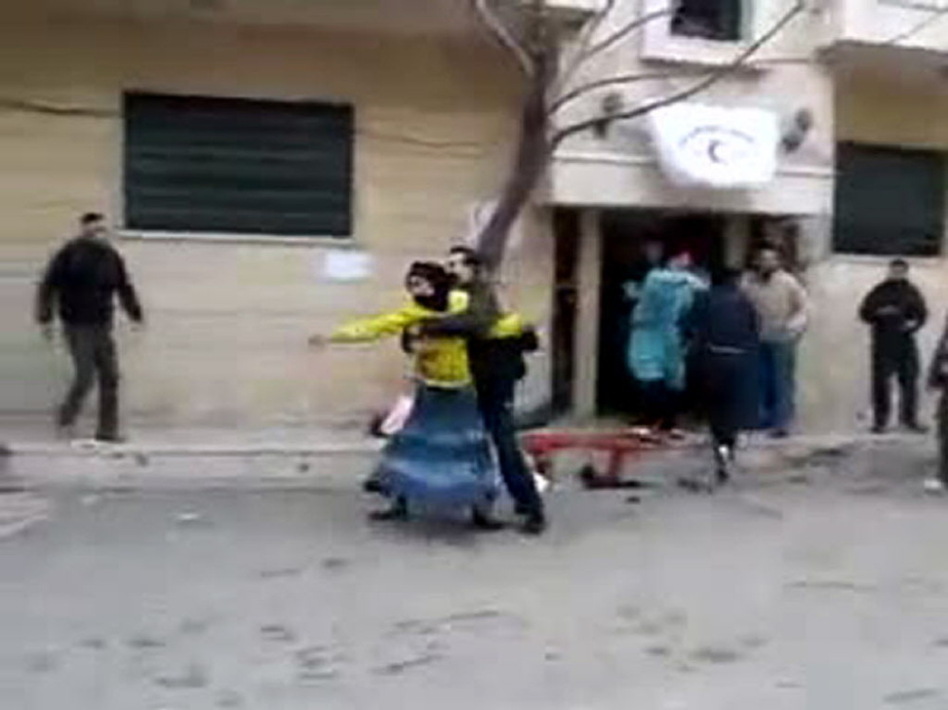Activists say this image, taken from a video uploaded to YouTube, shows Syrians outside a field hospital in Homs last week. (AFP/Getty Images)