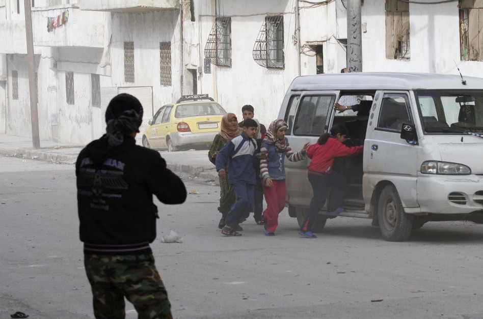 Civilians flee from fighting on Tuesday, after Syrian army tanks enter the northwestern city of Idlib, Syria. (Anonymous/AP)