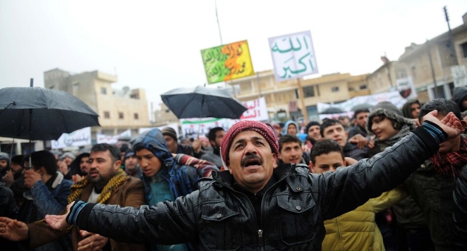 Syrians demonstrate against the regime after Friday prayers in the north Syrian city of Idlib on Friday. Thousands of Syrians rallied to demand Bashar al-Assad's ouster, as the embattled president's forces unleashed their heaviest pounding yet of Homs in a brutal bid to crush dissent, monitors said. (Bulent Kilic /AFP/Getty Images)