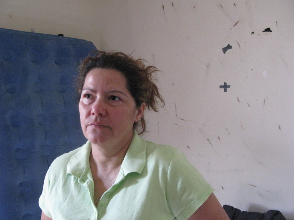 Luz Escamilla's bedroom walls are stained with the blood of bedbugs. She says she doesn't want to bleach them until reps from CW Capital, her landlord, pay an in-person visit to her Maryland home. (Aarti Shahani/NPR)