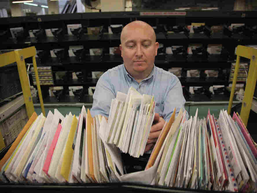 A Royal Mail worker holds letters of donations to the Pakistan Floods Appeal.Â