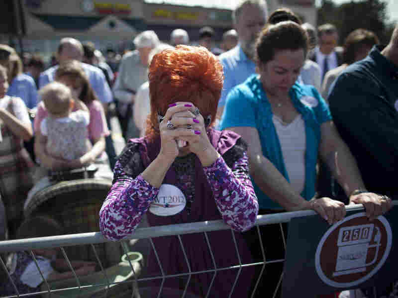 Supporters of Republican presidential candidate, former House Speaker Newt Gingrich pray during a rally in Woodstock, Ga., Thursday, March 1, 2012.